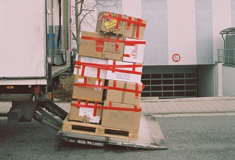 brown cardboard boxes on gray asphalt road